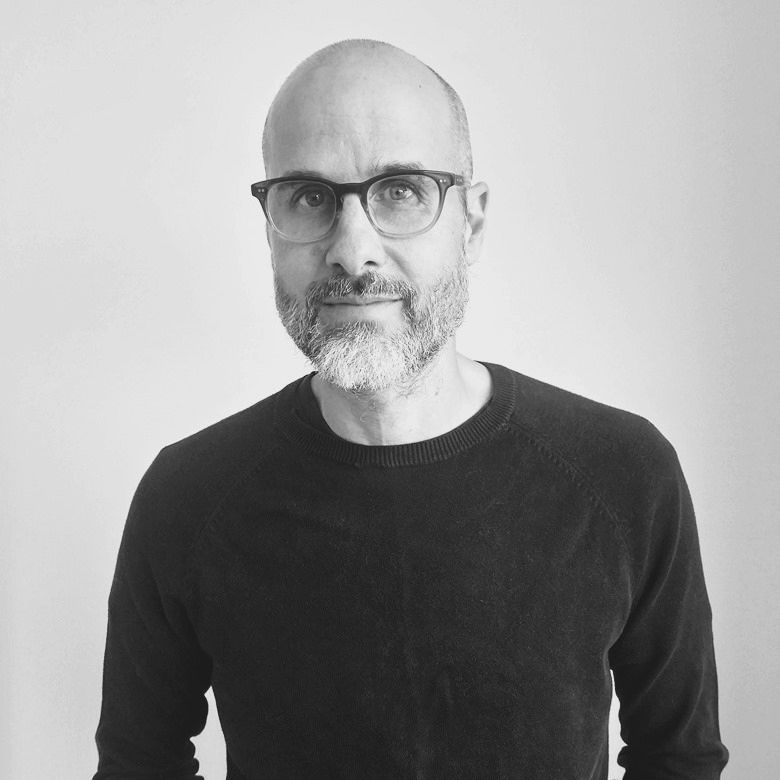 Black and white image of Eric Fillion standing in a sweater 