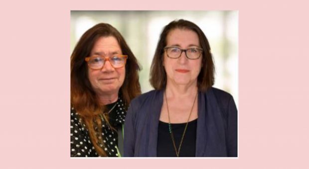 Karen Dubinsky, a woman with long auburn hair and orange rimmed glasses, and Susan Lord, a woman with dark shoulder-length hair and black rimmed glasses.