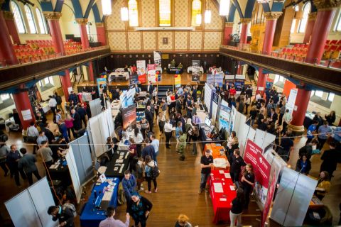 An image of students gathered in Grant Hall touring department booths