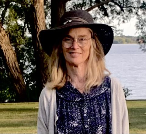 Photo of Emily Hill with a scene of Lake Ontario in the background