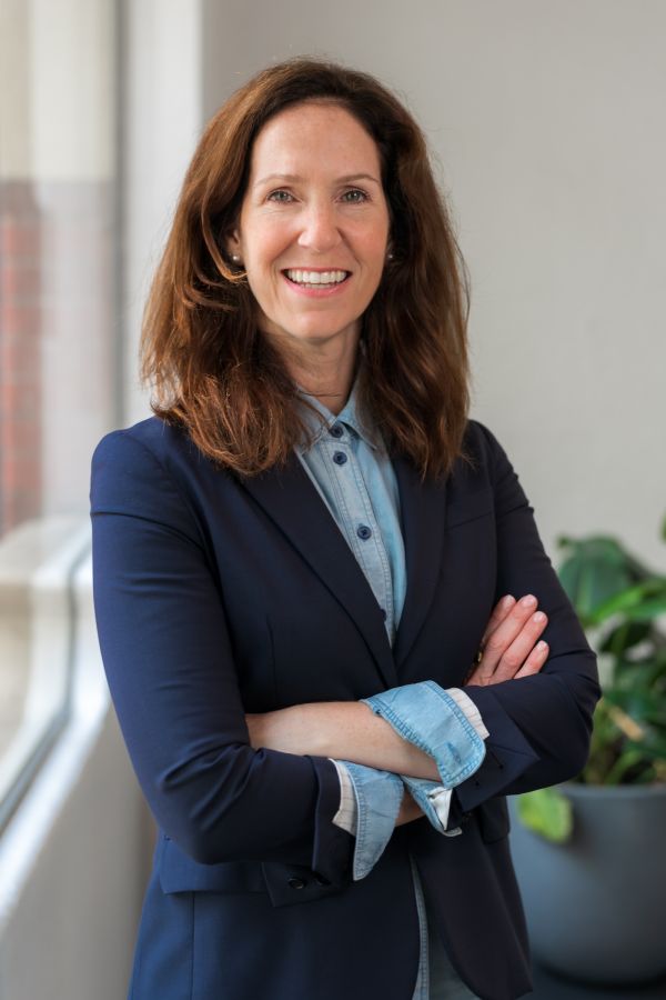 Image of Gillian Pearl smiling in an office