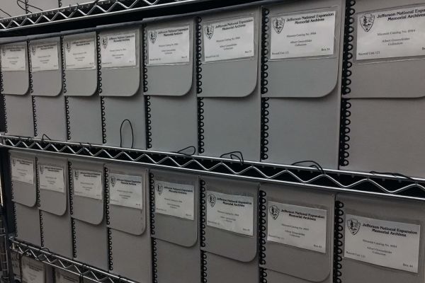 Image of a shelf full of archival storage boxes