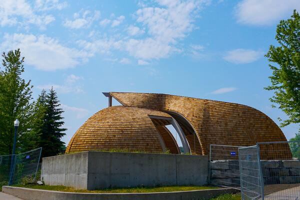 [wooden structure, blue sky, the outdoor indigenous gathering space]