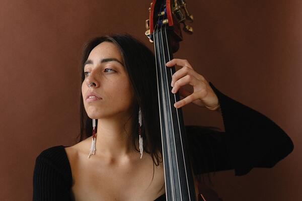 indigenous artist with instrument 