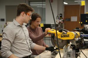 Two woodworkers use the table saw in SparQ Studios