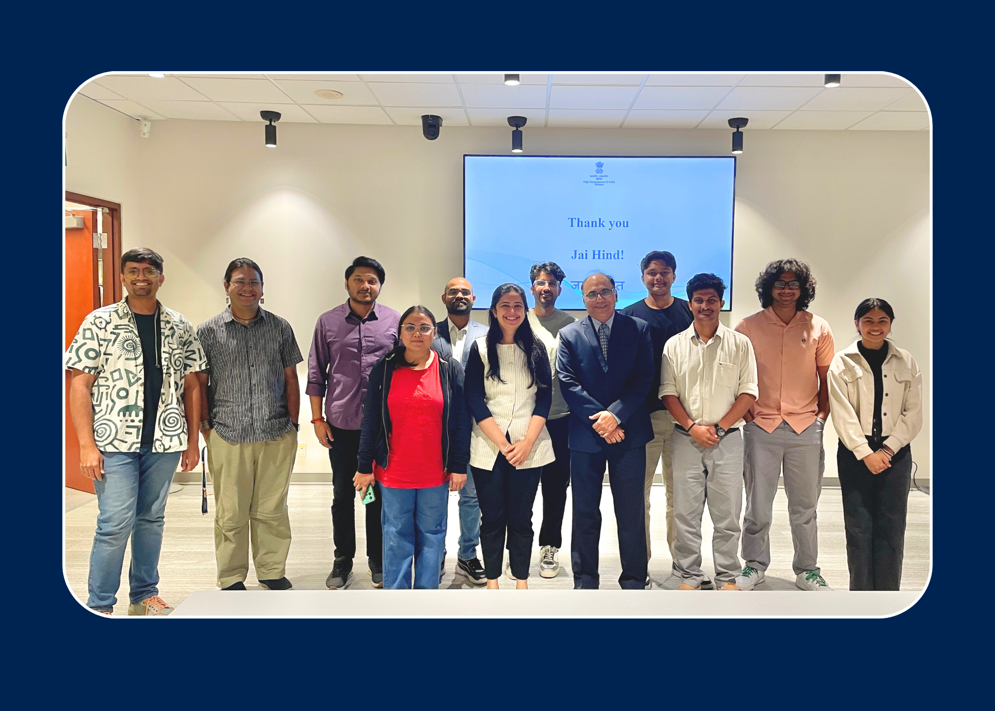 High Commissioner Standing with ten Queen's Students