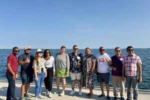 Group of 10 international guidance counsellors posing together with Lake Ontario in the background