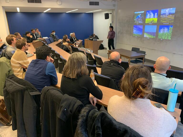 Dr. Cao Thang Dinh Delivering a talk to a group of individuals who are seated