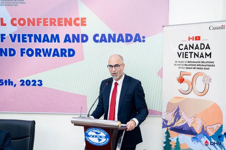 The Canadian Ambassador in Hanoi standing at a podium