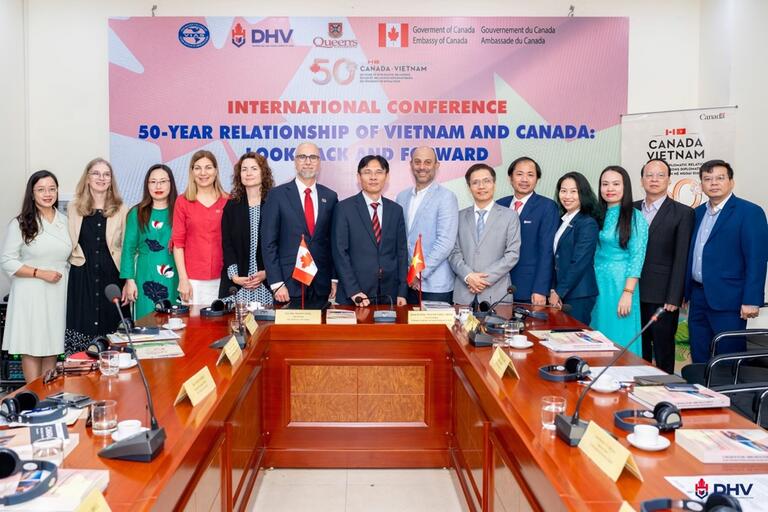 Group photo of attendees in front of banner reading "International Conference: 50-Year Relationship of Vietnam and Canada: Look Back and Forward"