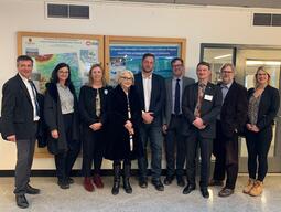 Delegation photo containing nine individuals, including Sandra den Otter from Queen's