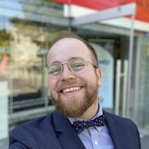 Photo of Man, Wearing Glasses, in front of the Agnes Art Building