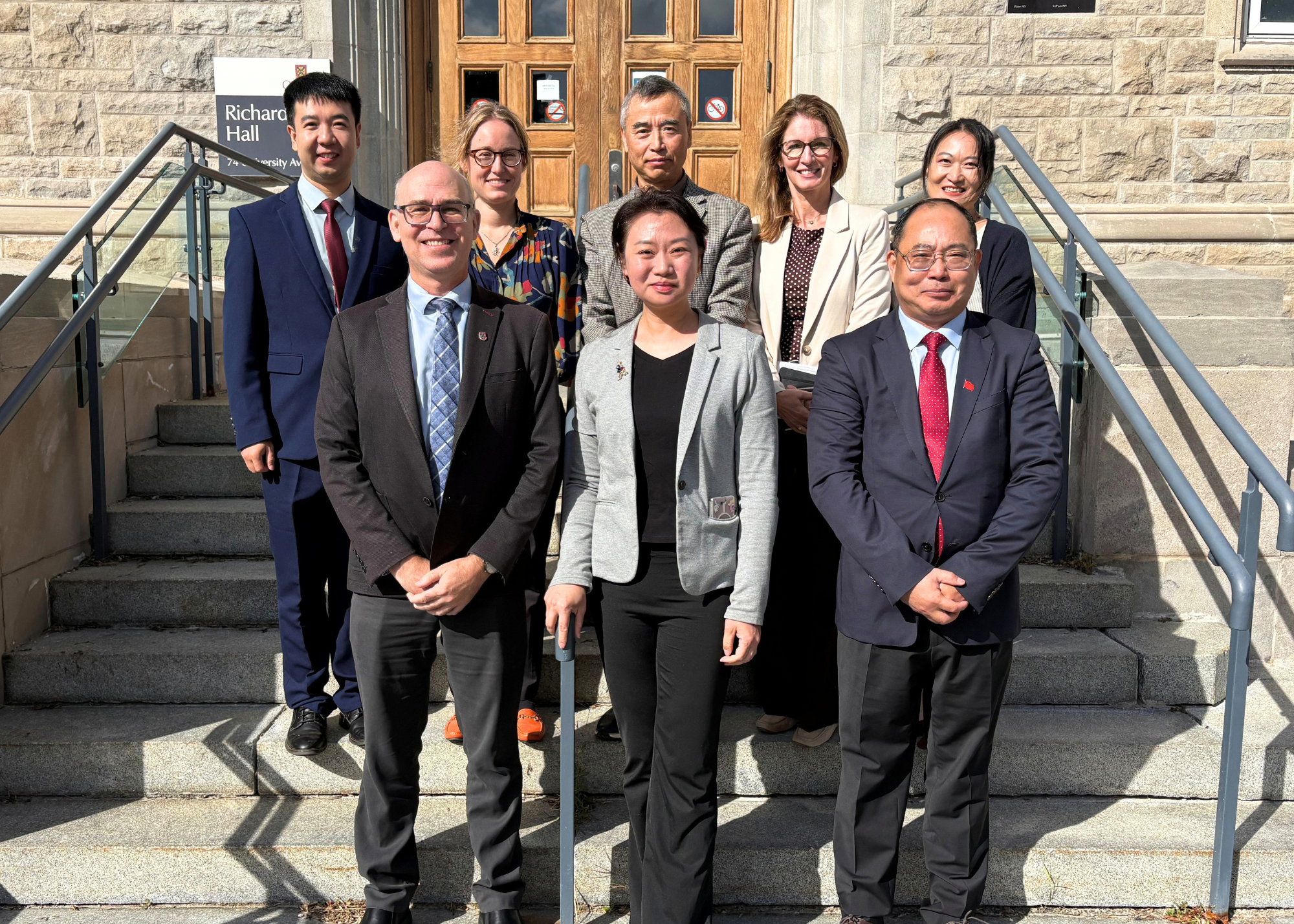 Representatives from Queen’s University and the Consulate-General of the People’s Republic of China in Toronto pose for a group photo outside Richardson Hall during a campus visit on September 21, 2026.