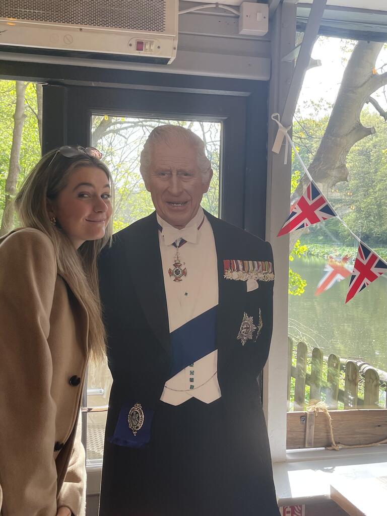 Patricia standing with a cardboard cut out of King Charles