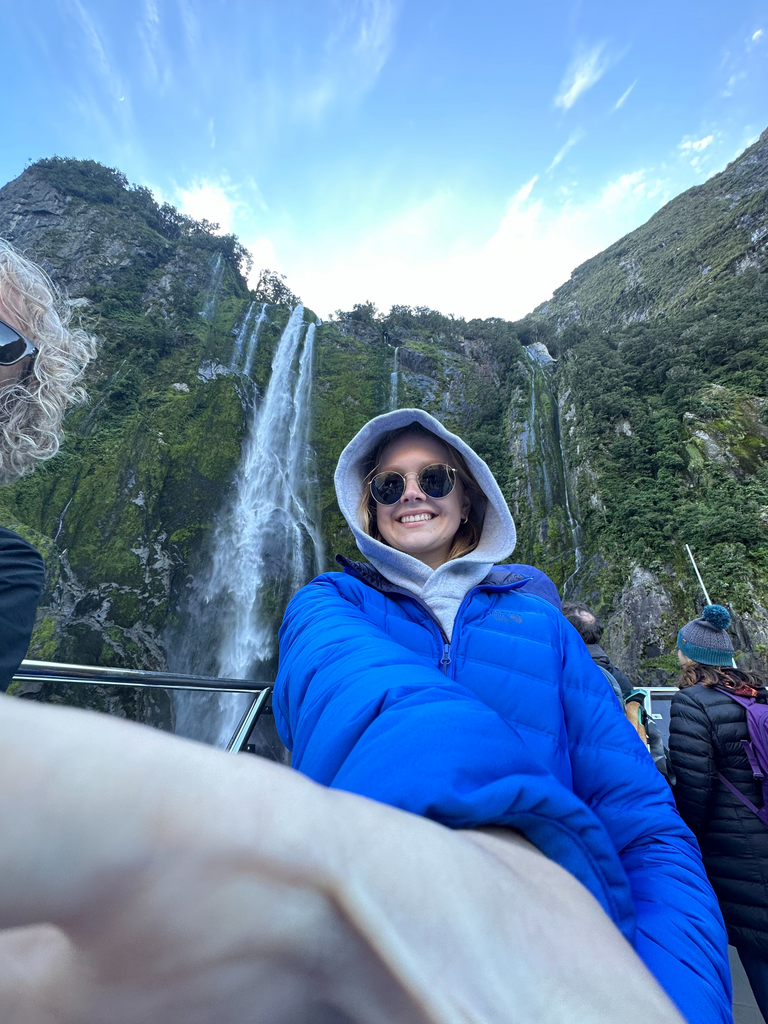 Sarah takes a selfie in front of waterfall
