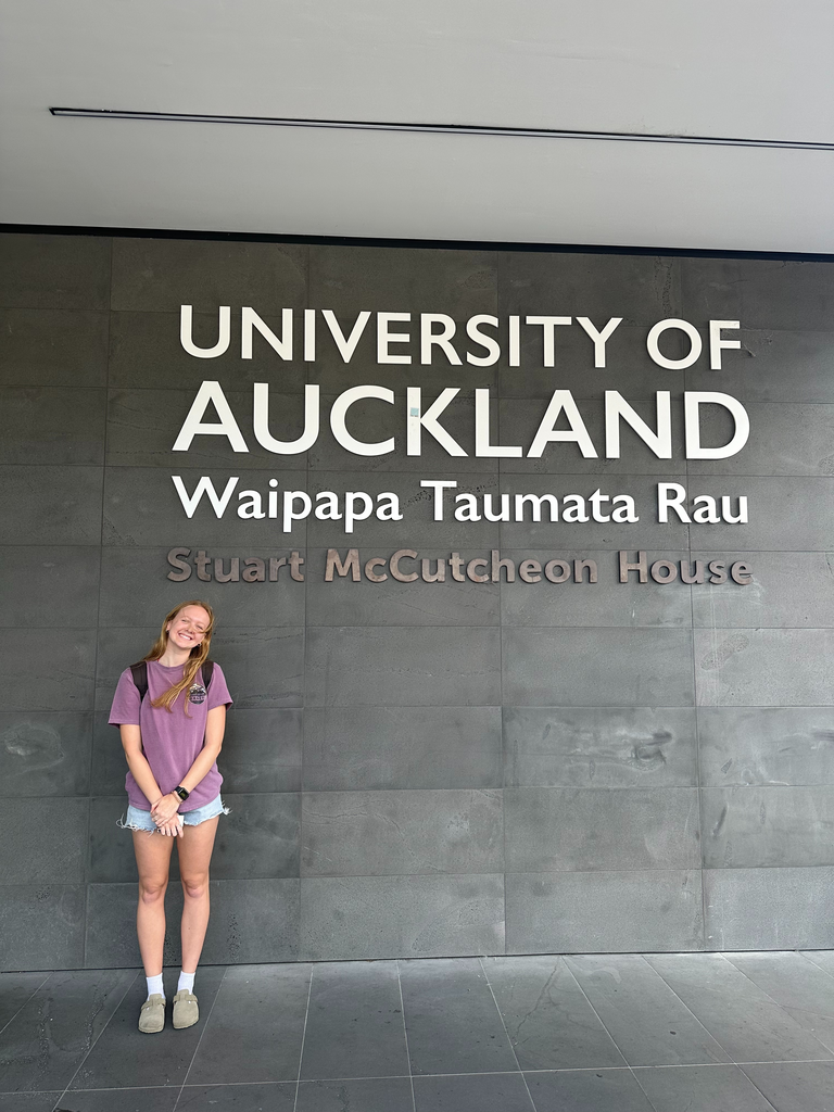 Sarah in front of University of Auckland sign