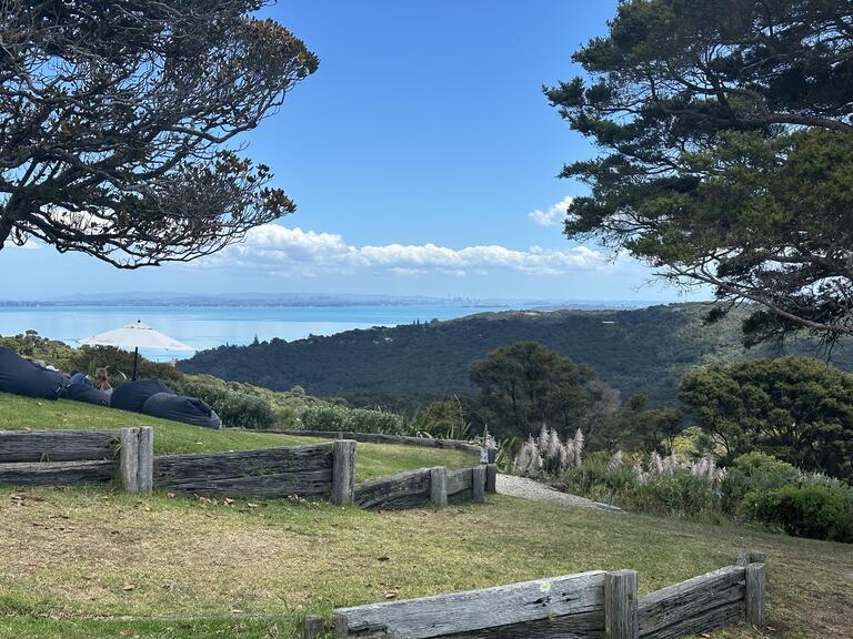 A view of rolling hills with water in the distance