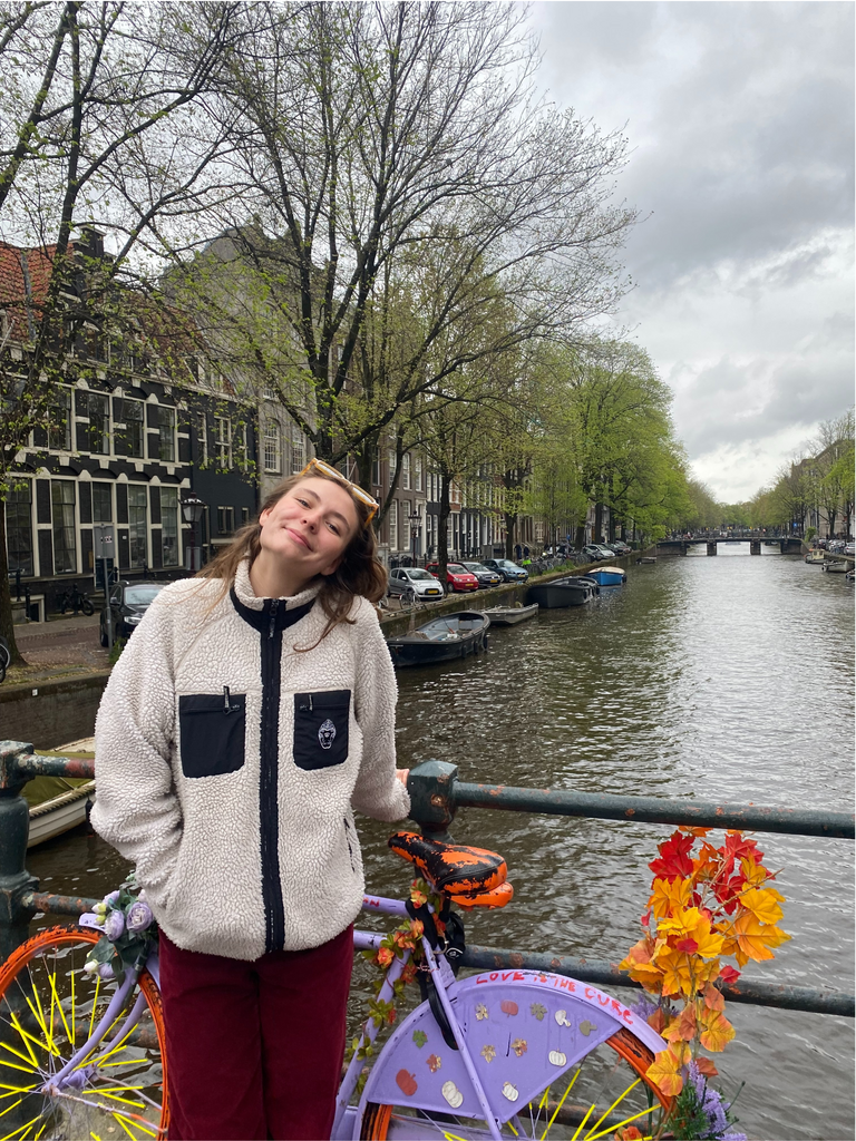 Isabel in front of a bicycle and a canal