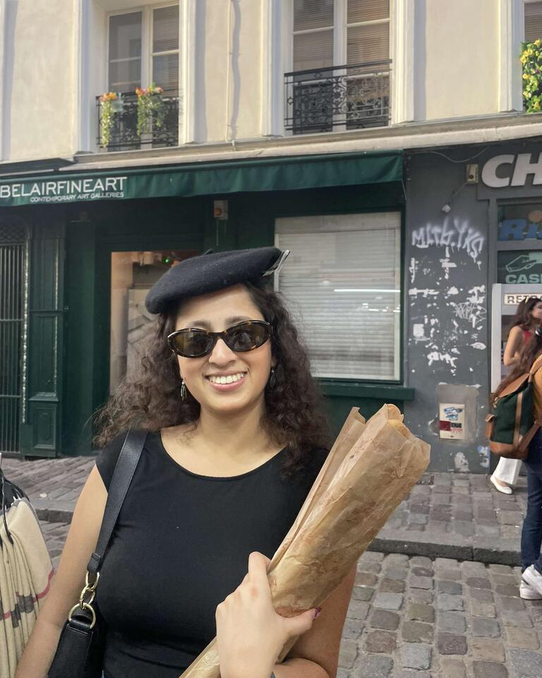 Anushka in a beret holding a baguette