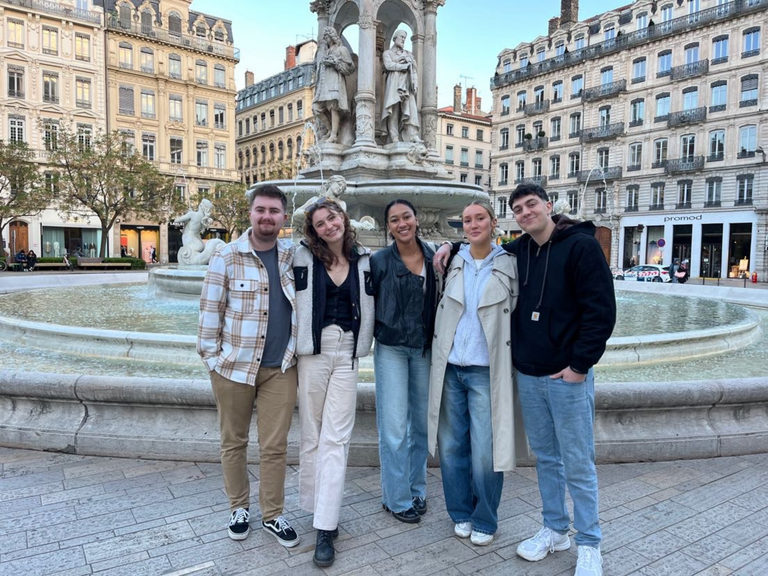 Isabel and friends in front of a French fountain