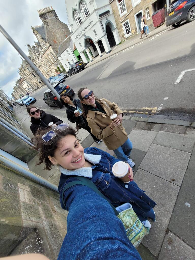 Valerie takes a selfie with friends in the back