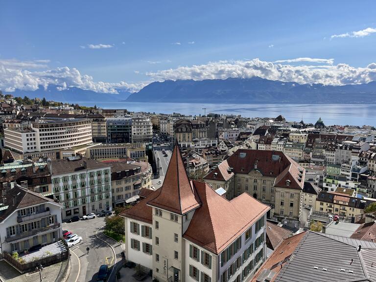 A beautiful rooftop view of the city, with mountains in the background.