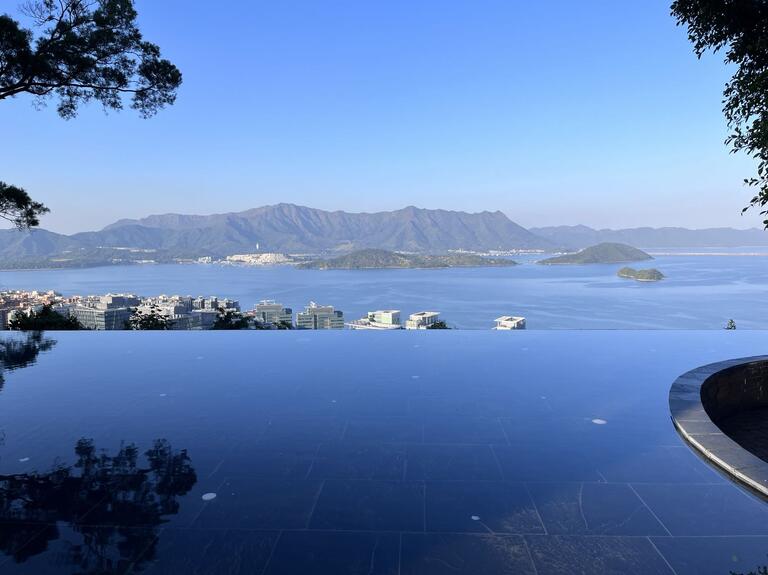 Body of water with rolling hills in the distance