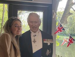Patricia standing with a cardboard cut out of King Charles