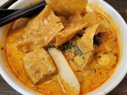 A bowl of food with chopsticks