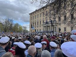 A large outdoor event swarming with people in matching white hats