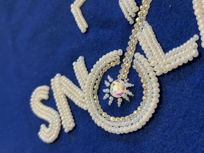 Beading Astroparticle Physics sneak peek of the SNOLAB logo in production. Photo by Danielle Lussier.