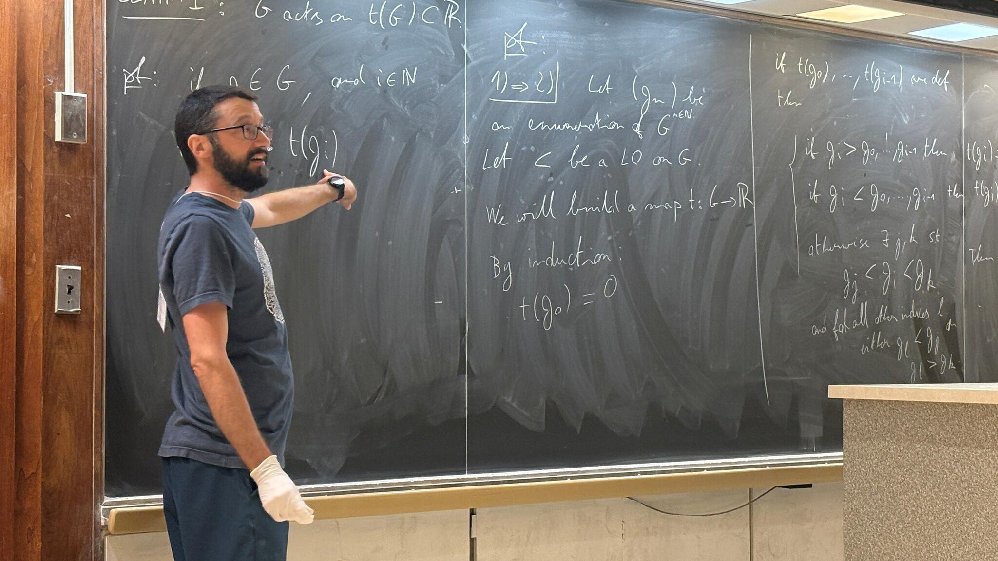 Mathematics Summer School Instructor Teaching and pointing at blackboard