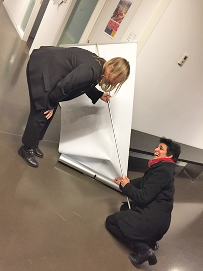 Reena and Kim laughing over fallen banner