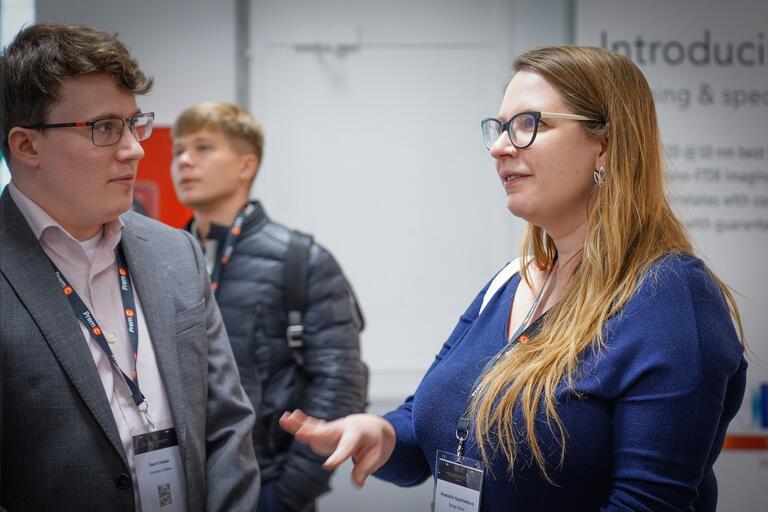 Gavin (PhD Student, Hughes group) discussing his poster on using coherent feedback to improve single photon sources at international Nanophotonics in Barcelona (NANOP 2023)
