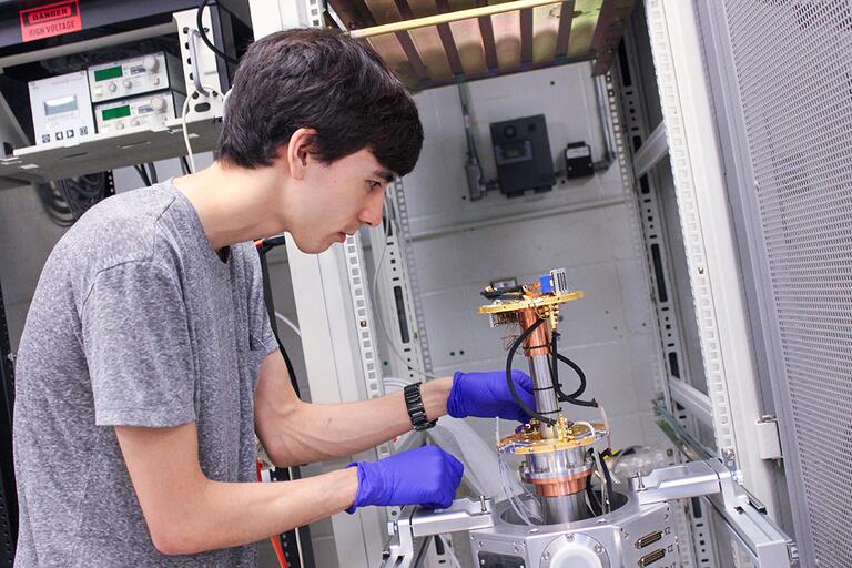 PhD Candidate, Marcus Tamura, exploring cryogenic neuromorphic photonic systems.