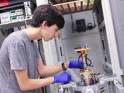 PhD Candidate, Marcus Tamura, exploring cryogenic neuromorphic photonic systems.