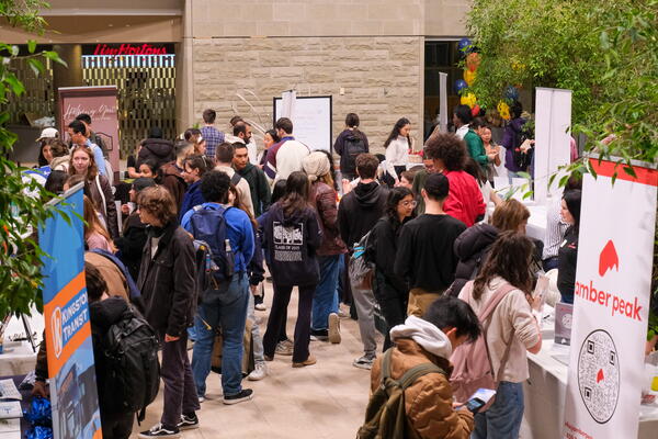 students chatting with a variety of booths
