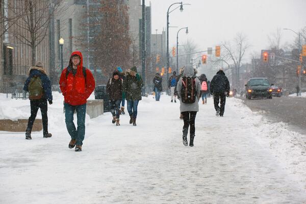 people walking on Kingston sidewalk near Queen's Campus during the winter