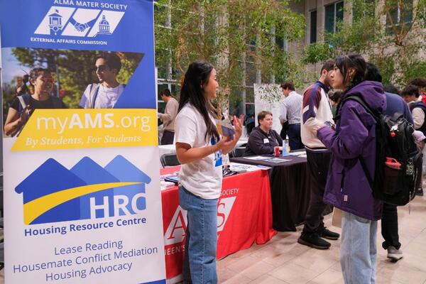 photo of students chatting at a resource booth. 