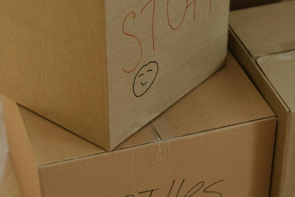 two boxes- one labelled stuff and the second labelled clothes. 