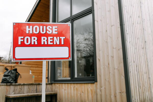 house with a sign that says "House for rent"