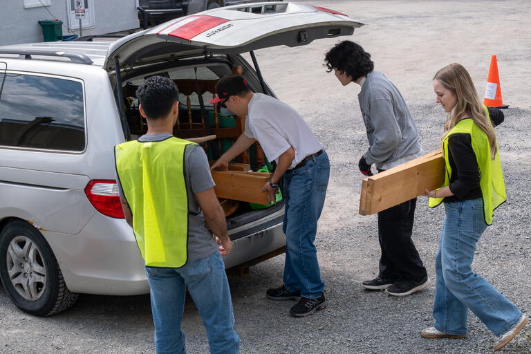 volunteers helping unload donations from the back of a van