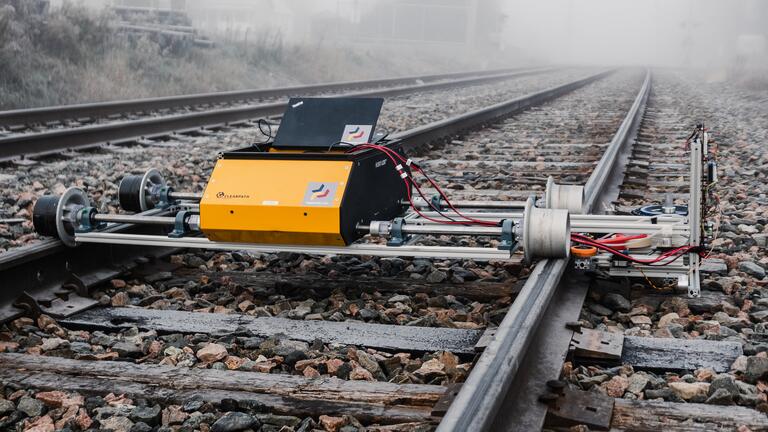 Robot on rails in the fog.