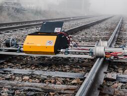 Robot on rails in the fog.