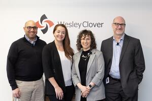 Hub350 panelists pose in front of a Wesley Clover wall