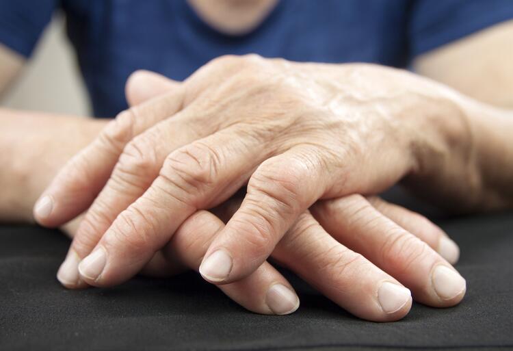 Stock photo of hands crossed on a surface