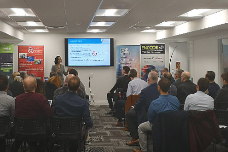 Feiran Zhou of Ontario Centres of Excellence addressees the group for the “How 5G and Next Generation Networks Programs Will Accelerate Your Business” presentation in the upper floor presentation space of Seaway Coworking.