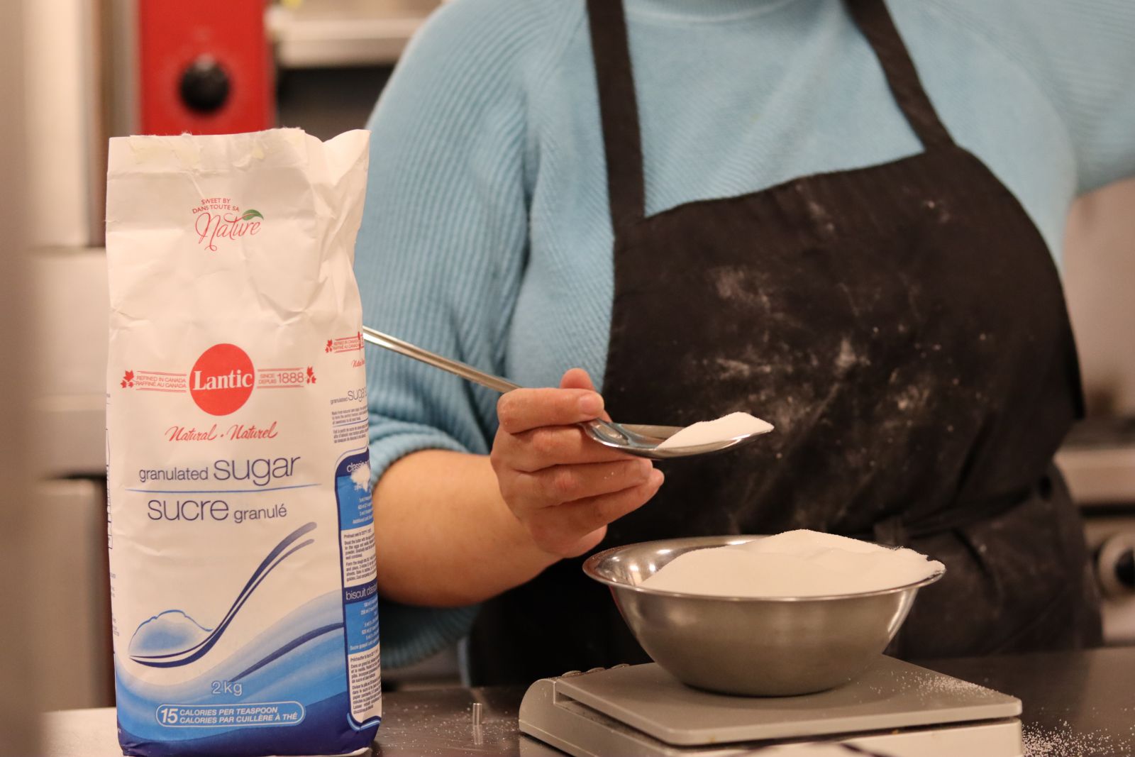 women scooping sugar
