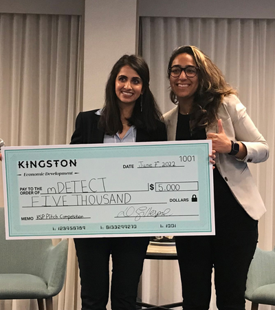 Irsa Shoukat accepting a cheque at a pitch competition