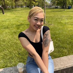 Photograph of Jazz Wong seated outside